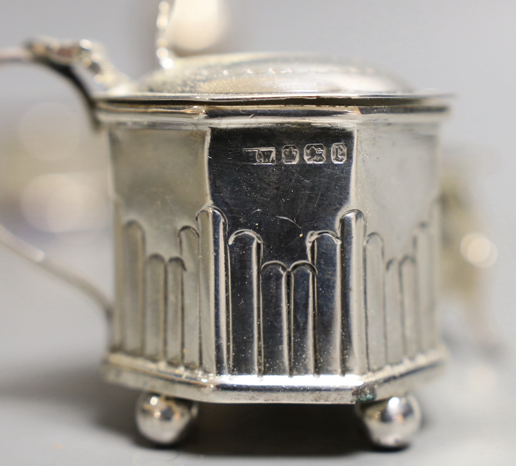 Six assorted silver condiments and a silver mounted cigarette box.